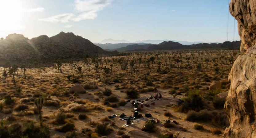 a group of people rest in joshua tree national park on an outward bound veterans expedition 